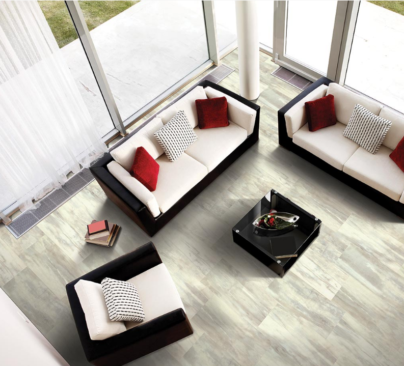 Mohawk marble lvt floors offer a luxurious feel to a bright living room with tall windows.