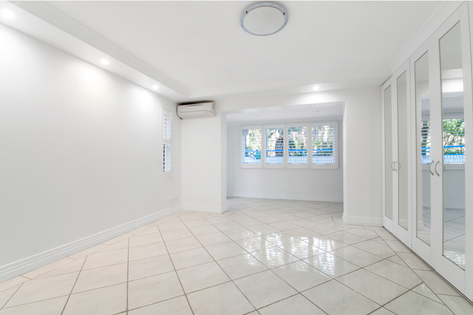 Bright room with large closets and light tile flooring